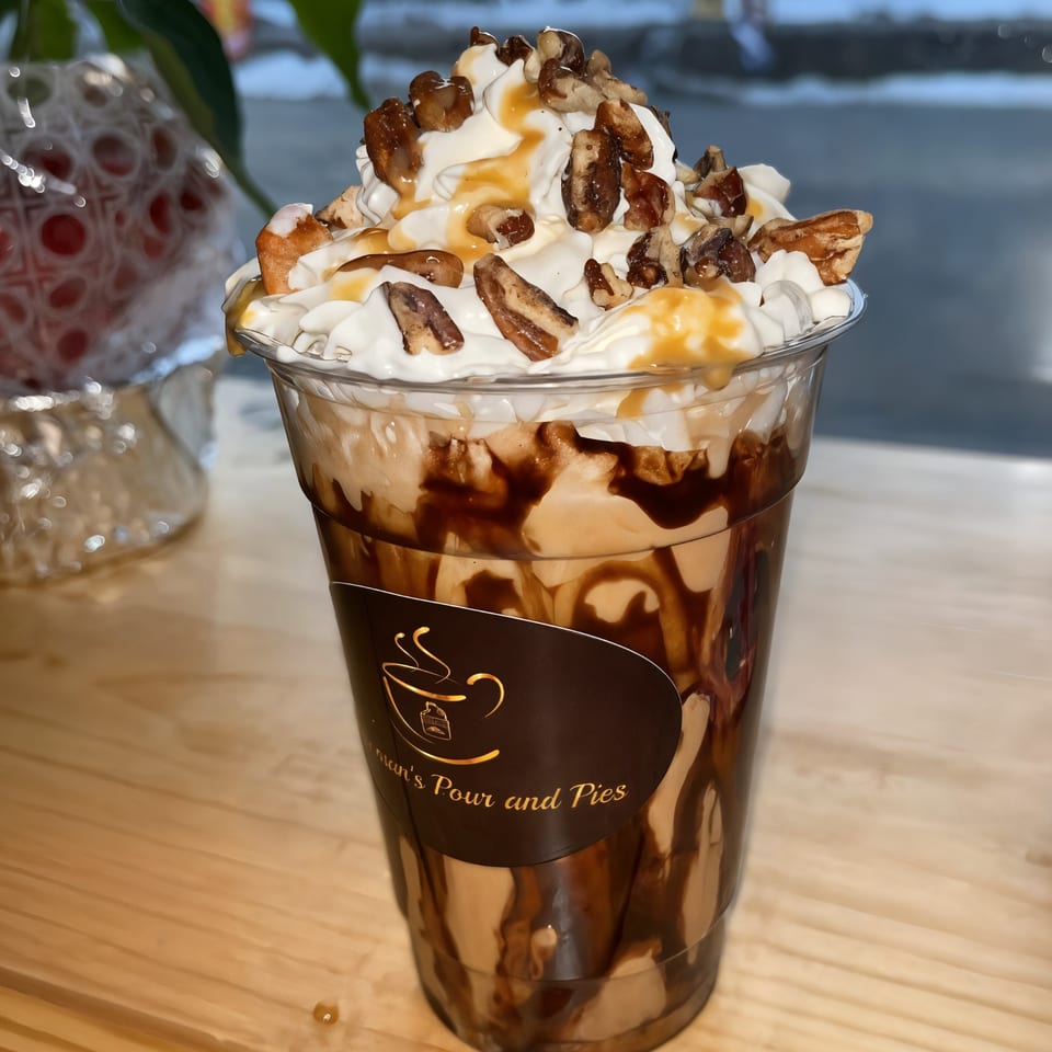 A Newman's Pour and Pies iced coffee with whipped cream, caramel, chocolate drizzle, and pecans.